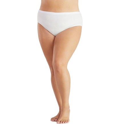 Bottom half of plus sized woman, facing front, wearing JunoActive Junowear Hush Midrise Brief in white. This brief fits a couple inches below the waistline with a conservative leg opening.