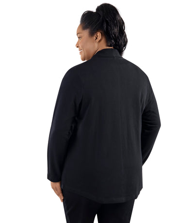 Plus-size model, facing backward, wearing JunoActive's Mavie Cotton Wrap Jacket in color black. Both hands by her side facing back.