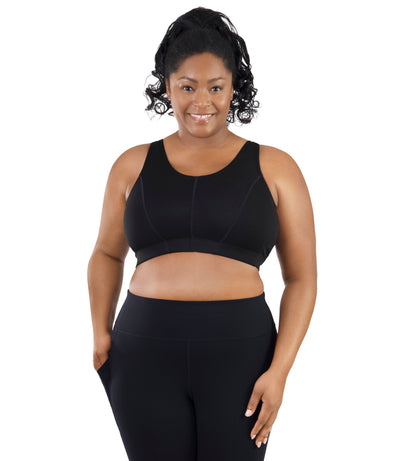 Comfort Support Back Clasp Sports Bra on model facing front in color black.