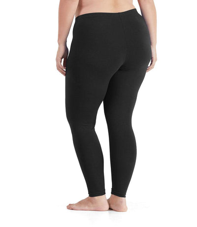 Bottom half of plus sized woman, back view, wearing JunoActive Stretch Naturals Leggings in color black. Bottom hem is at the ankle. 