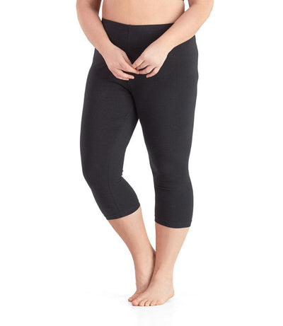 Bottom half of plus sized woman, front view, wearing JunoActive Stretch Naturals Capris in color black. Bottom hem is at mid-calf. 