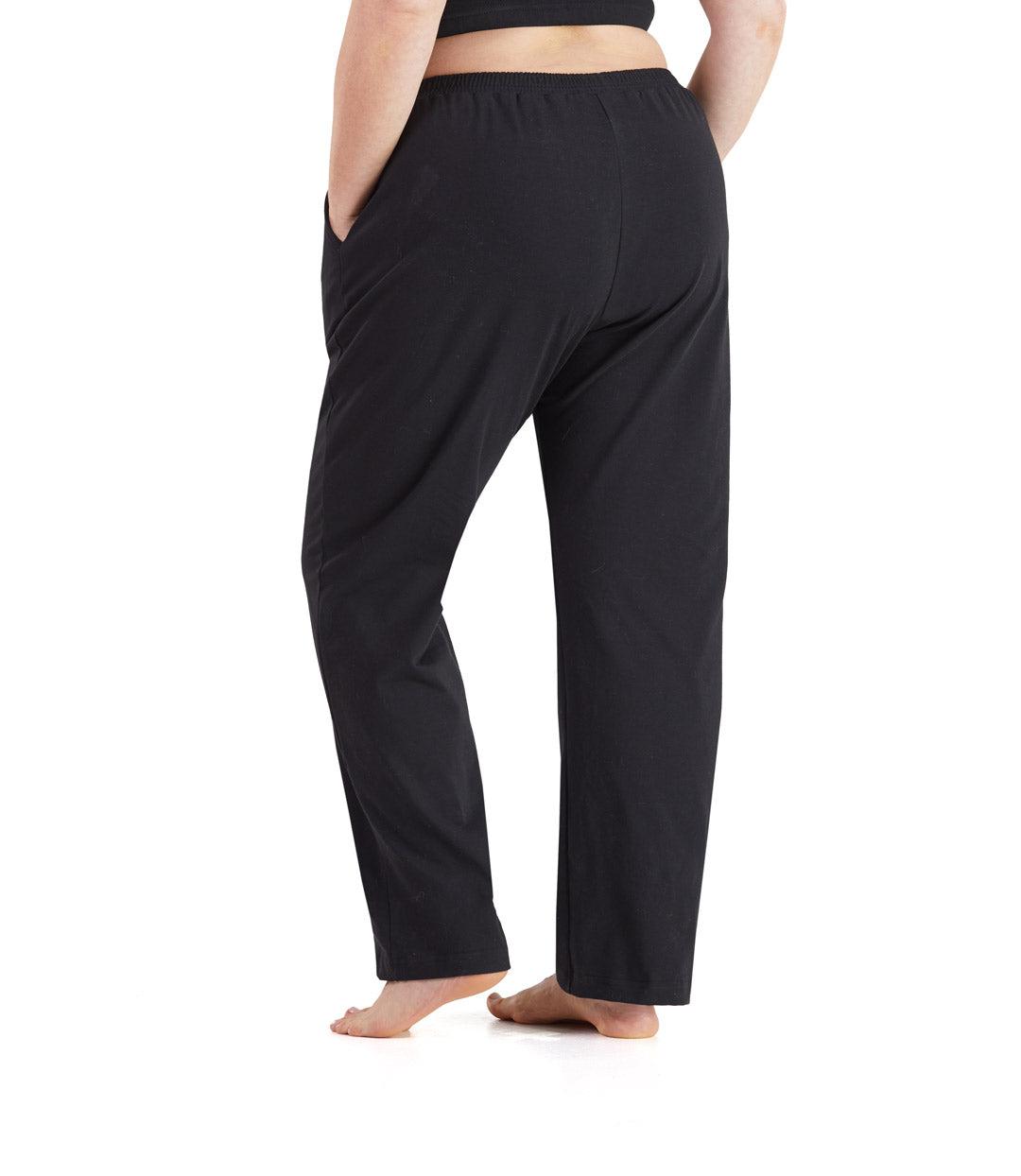 Bottom half of plus sized woman, back view, wearing JunoActive UltraKnit Slash Pocket Pant in color black. Bottom hem is at the ankle. 