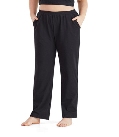 Bottom half of plus sized woman, front view, wearing JunoActive UltraKnit Slash Pocket Pant in color black. Bottom hem is at the ankle. 