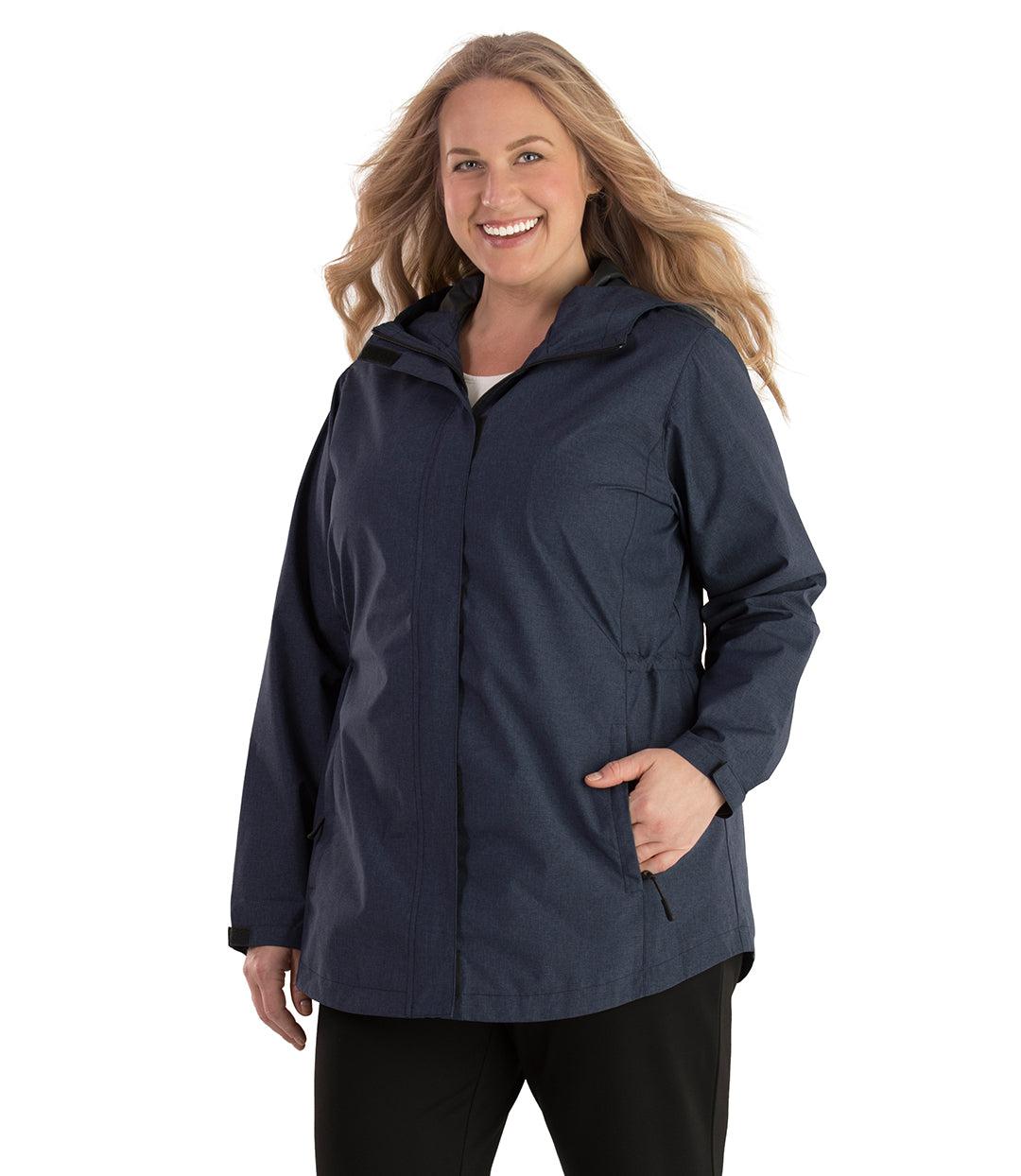 Plus size woman, front view, wearing a JunoActive plus size Waterproof Breathable Wind & Rain Jacket in navy blue. The jacket has a hood, double front closure and side pockets. The length of the plus size jacket hits just below the hips.