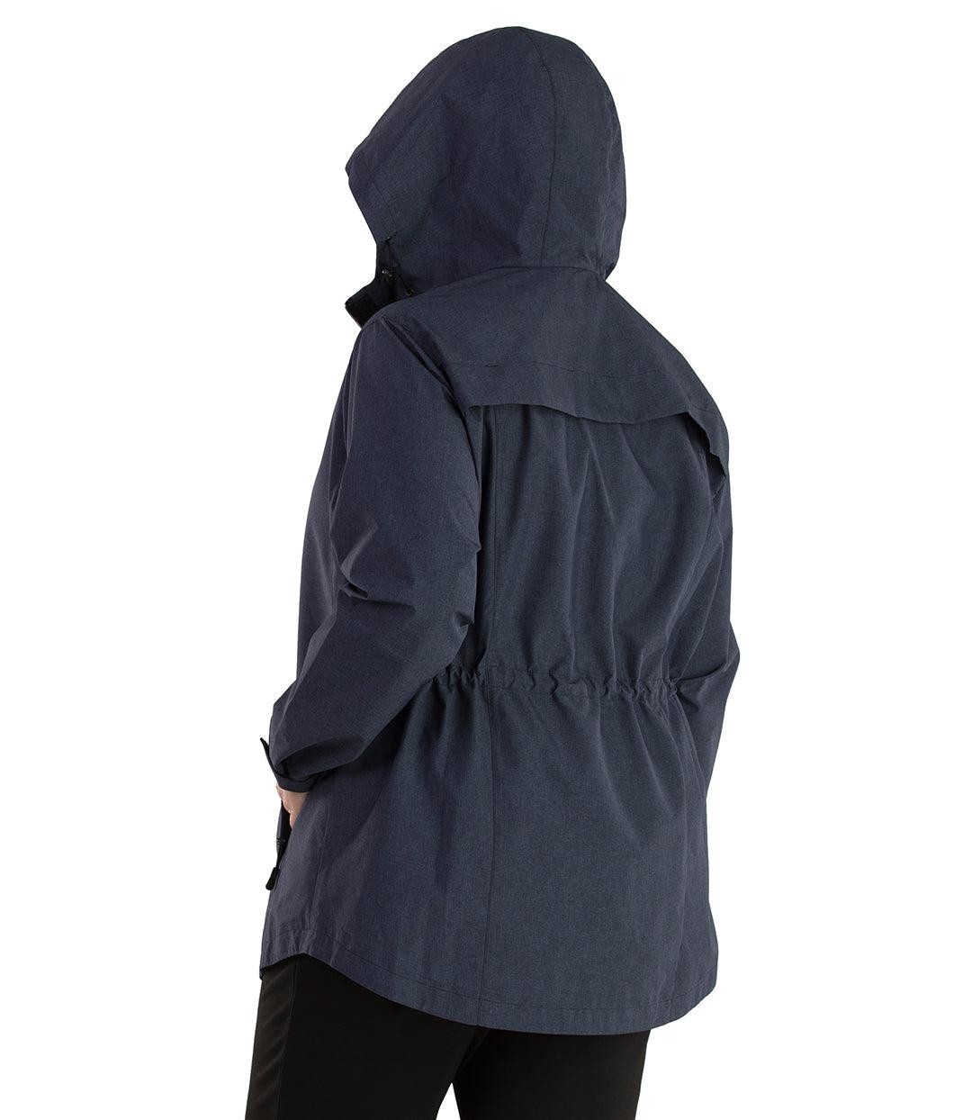 Plus size woman, back view with hood up, wearing a JunoActive plus size Waterproof Breathable Wind & Rain Jacket in navy blue. The jacket has a cinched waist, hood, double front closure, vent at back shoulder and side pockets at the hip. The length of the plus size jacket hits just below the hips.