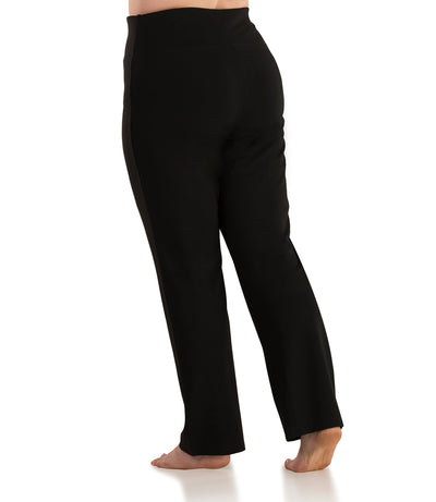 Back view of Bottom half of plus sized woman wearing JunoActives QuikFlex™ Yoga Pant Straight Leg Plus Size Active Pant in solid black. The pants are full length and do not have pockets.